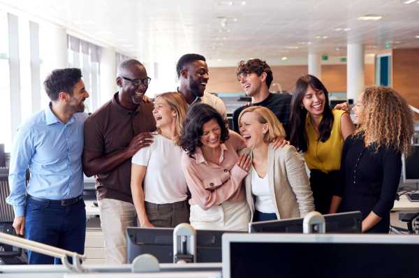 Happy employees behind a desk.